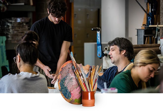 Students work with a professor in ceramics class in the fire arts building.