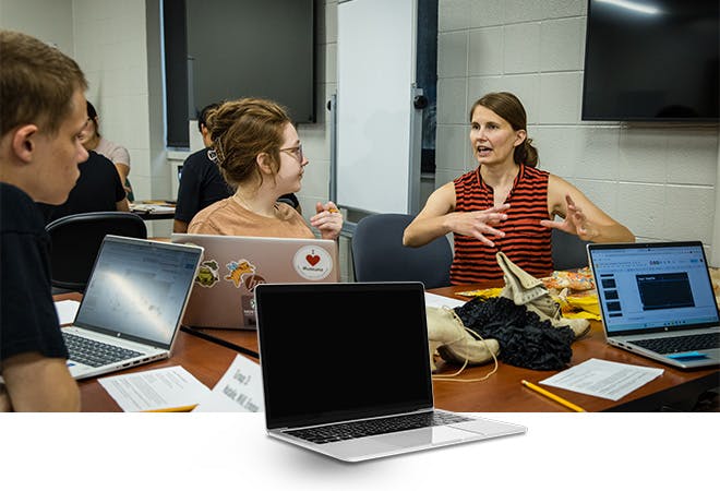 Dr. Ford talks with her students in History class.