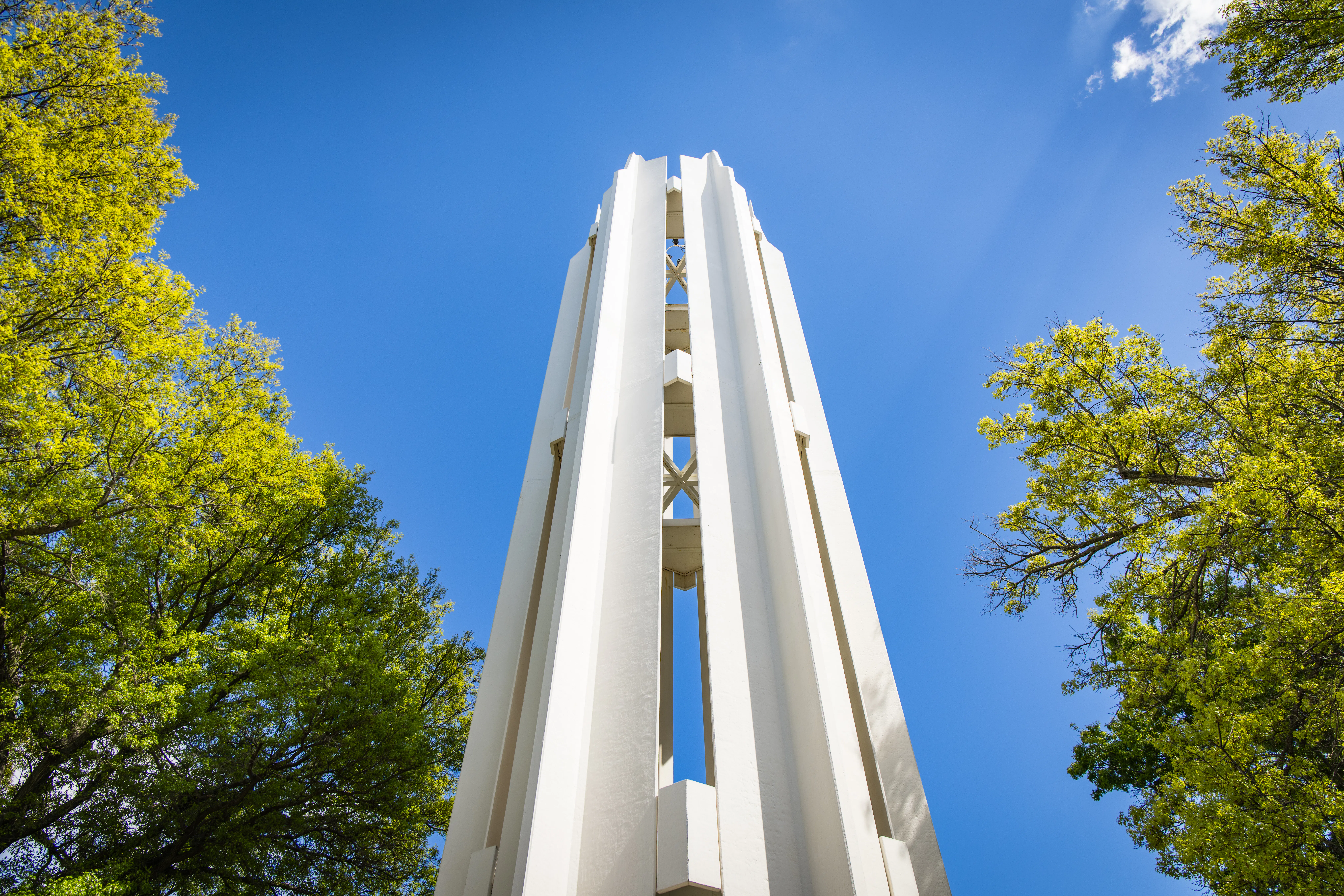 Memorial bell tower with a clear blue sky behind it.