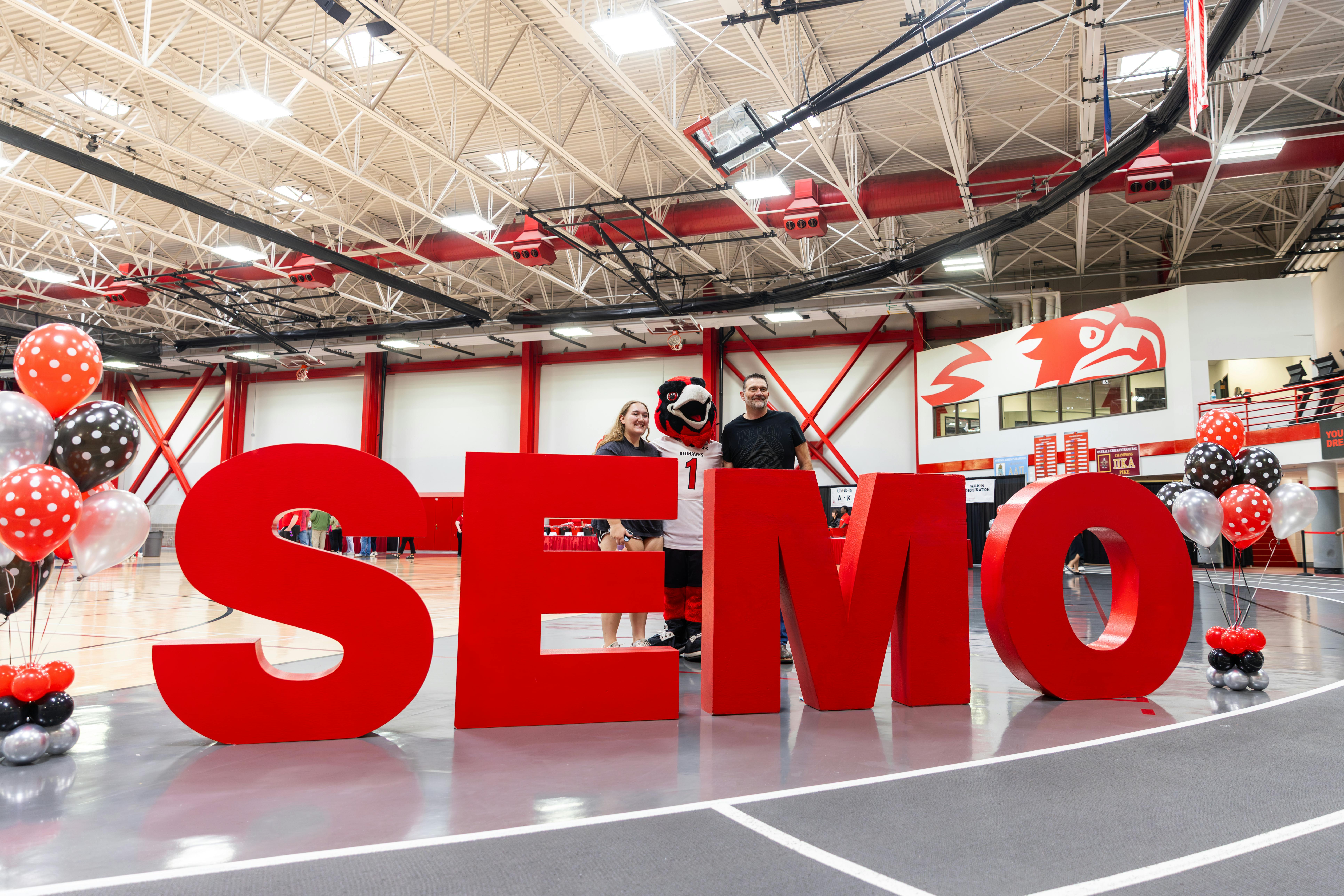 Rowdy the Redhawk smiling with student during Show Me Day on Campus
