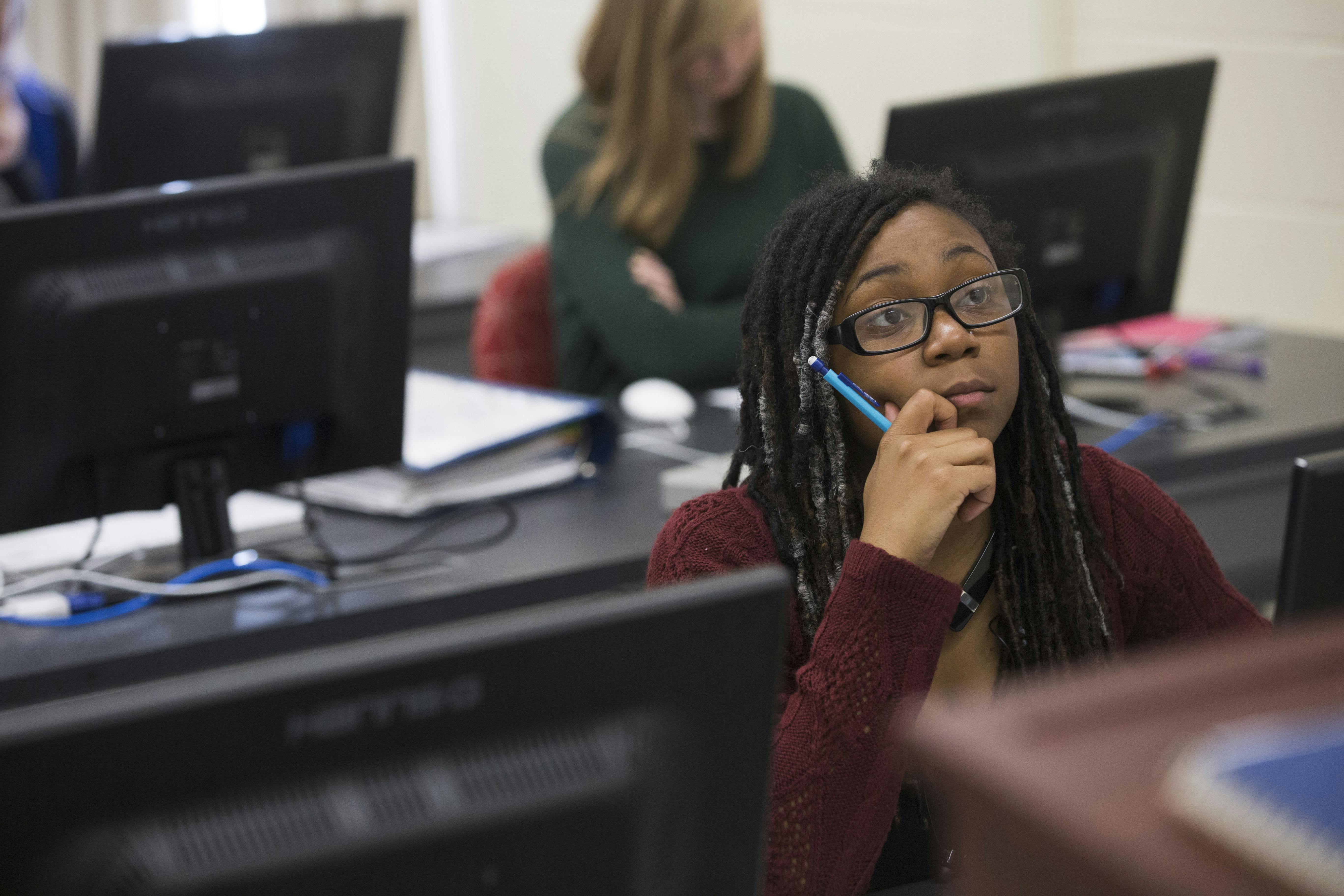 photo of a girl sitting in a computer lab classroom