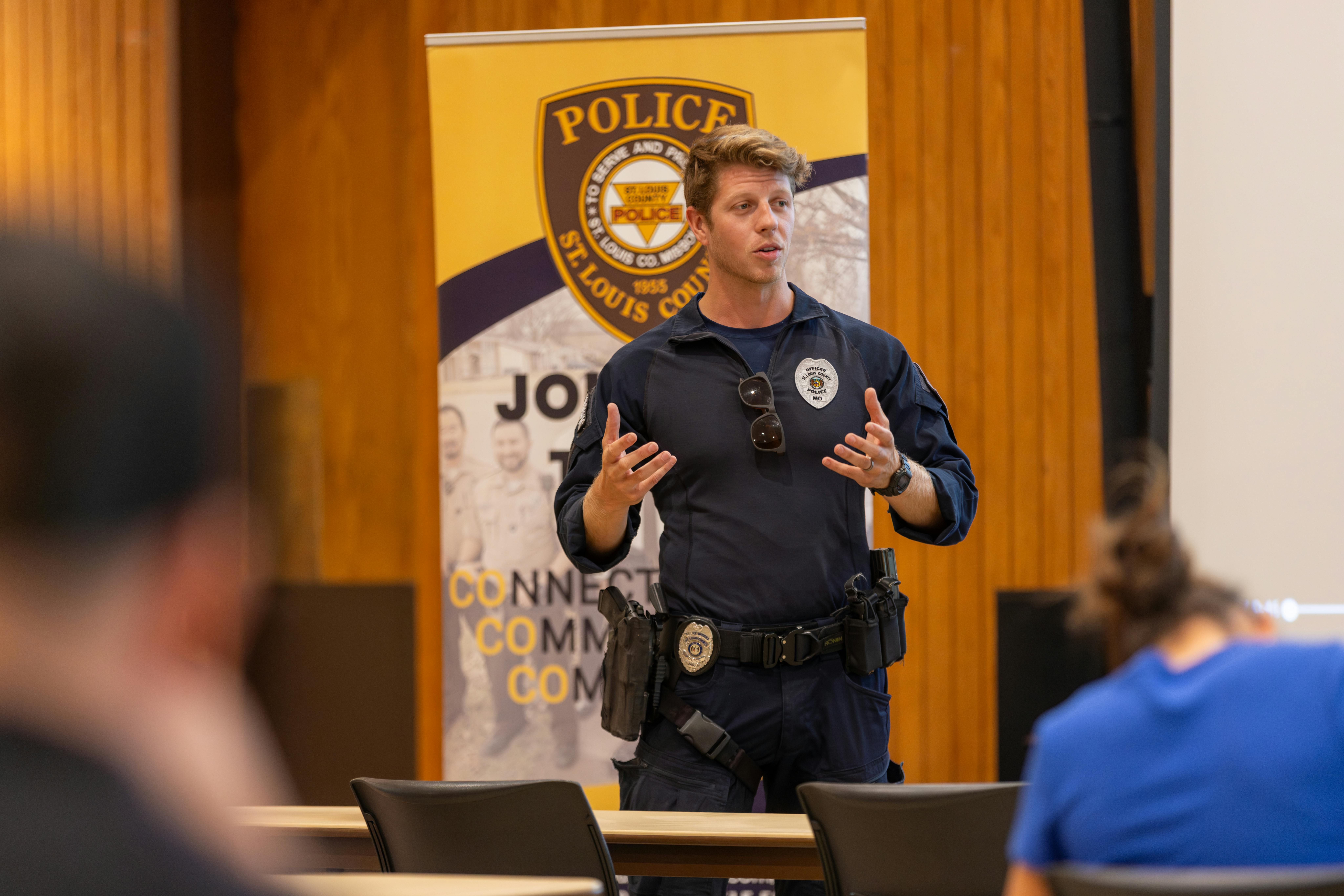 a police office sharing his experience with current students in a classroom