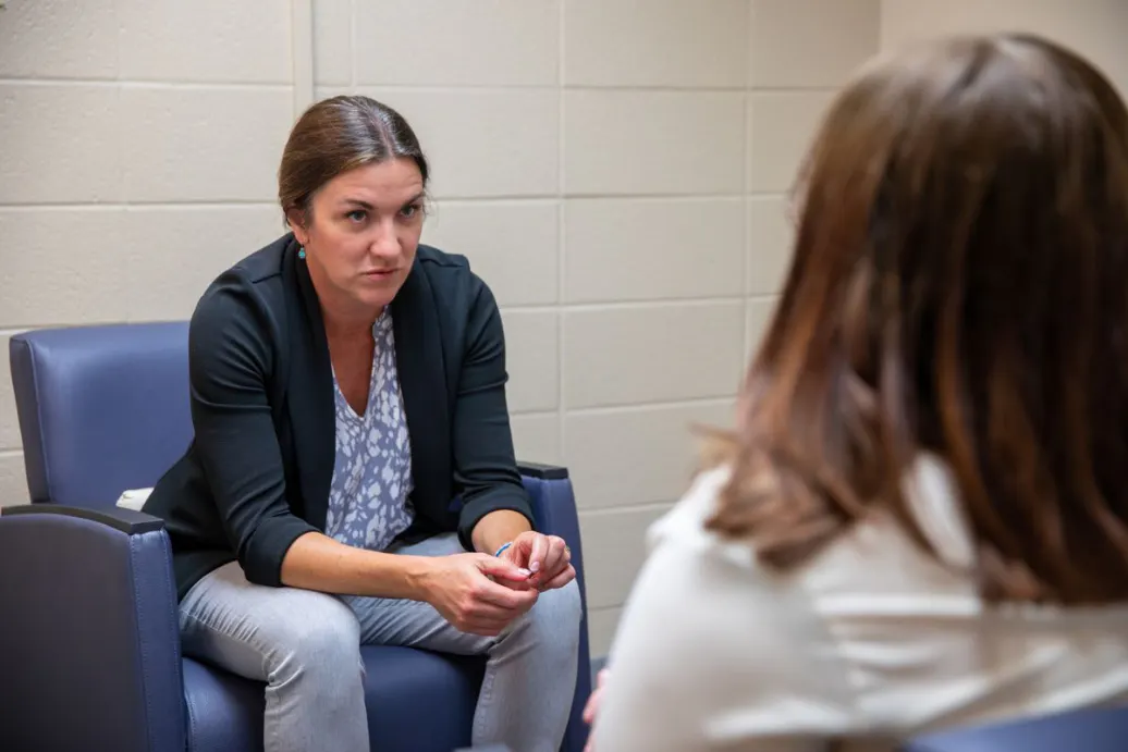 Woman speaking with another person in a counseling session