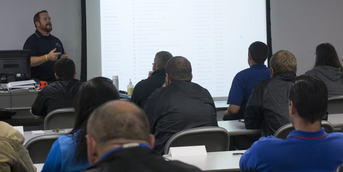 Image of a man leading a classroom.