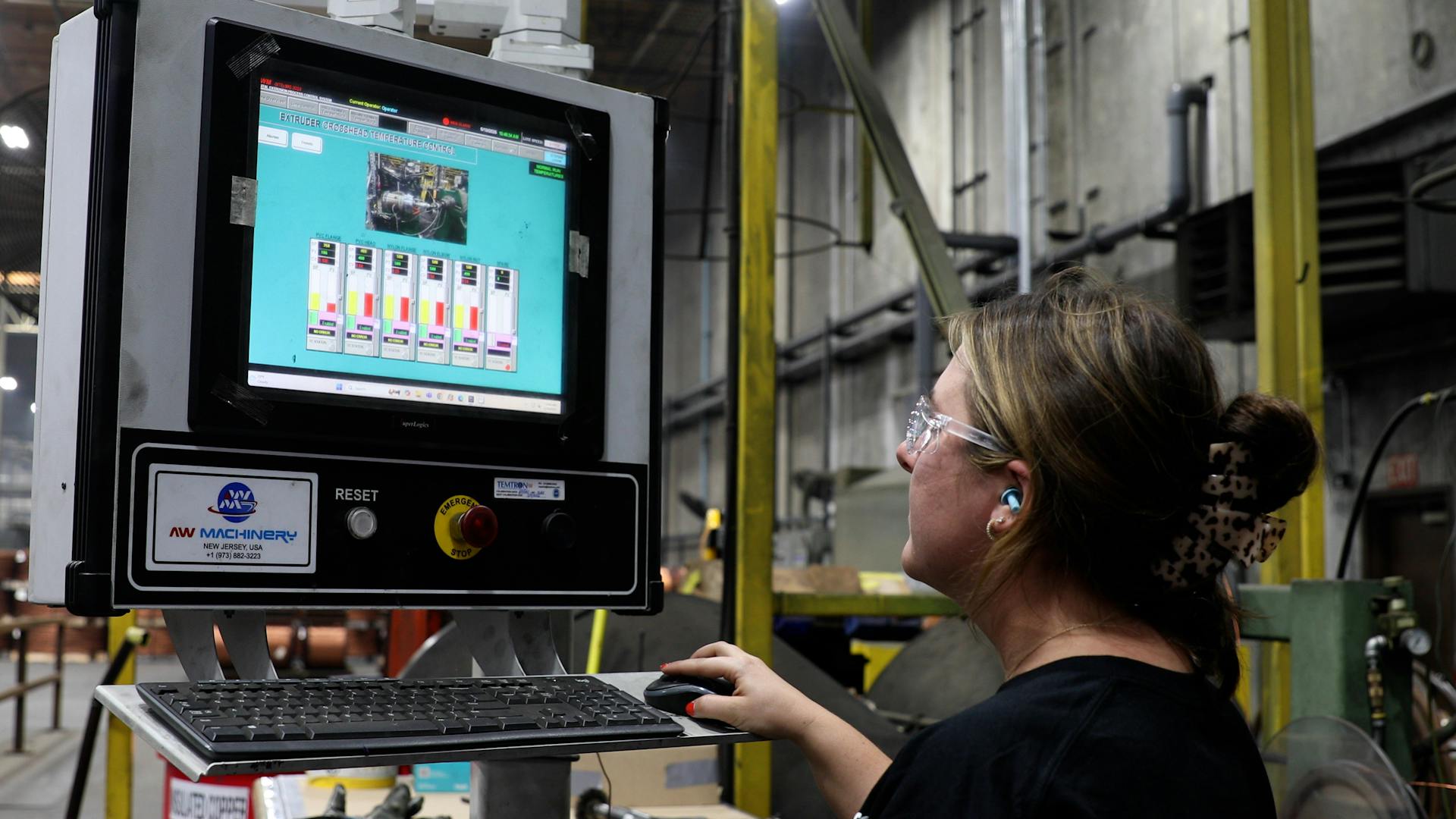 a female student works at a computer on the floor at alan wire 