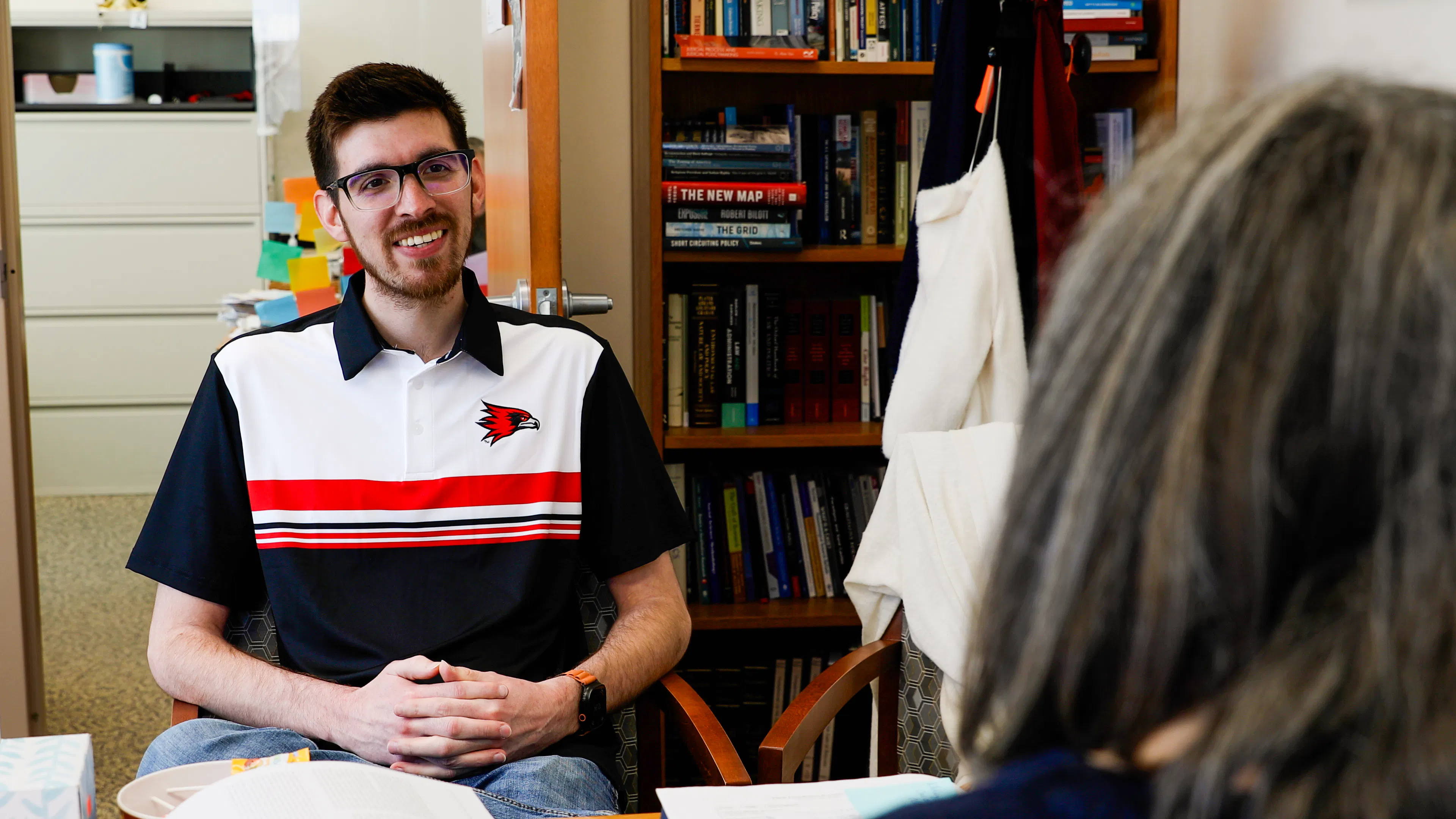 Caleb, SEMO alum, happily has conversation with professors in the political science program.