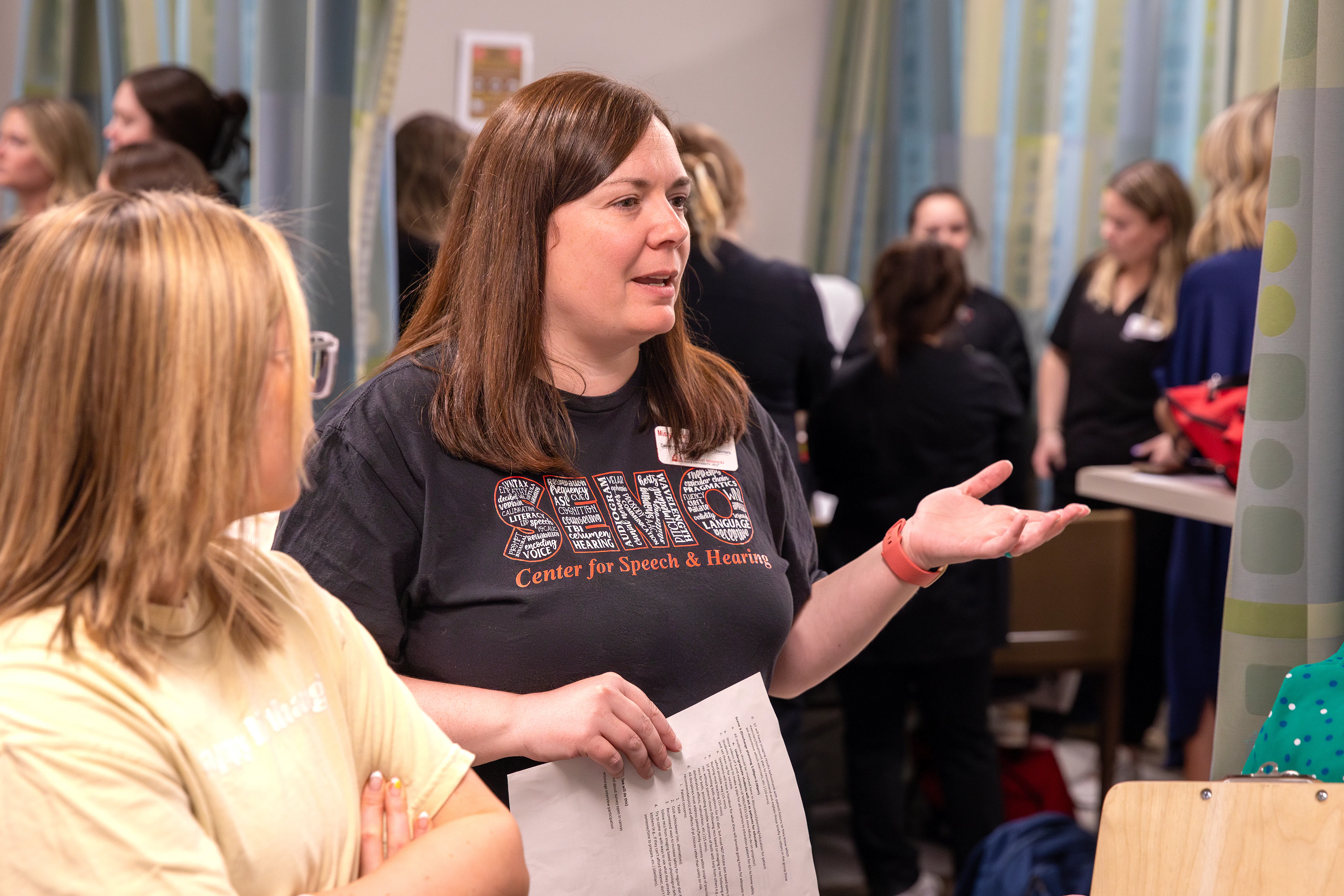 Dr. Misty Tilmon answers a student's question in the Speech and Hearing Clinic