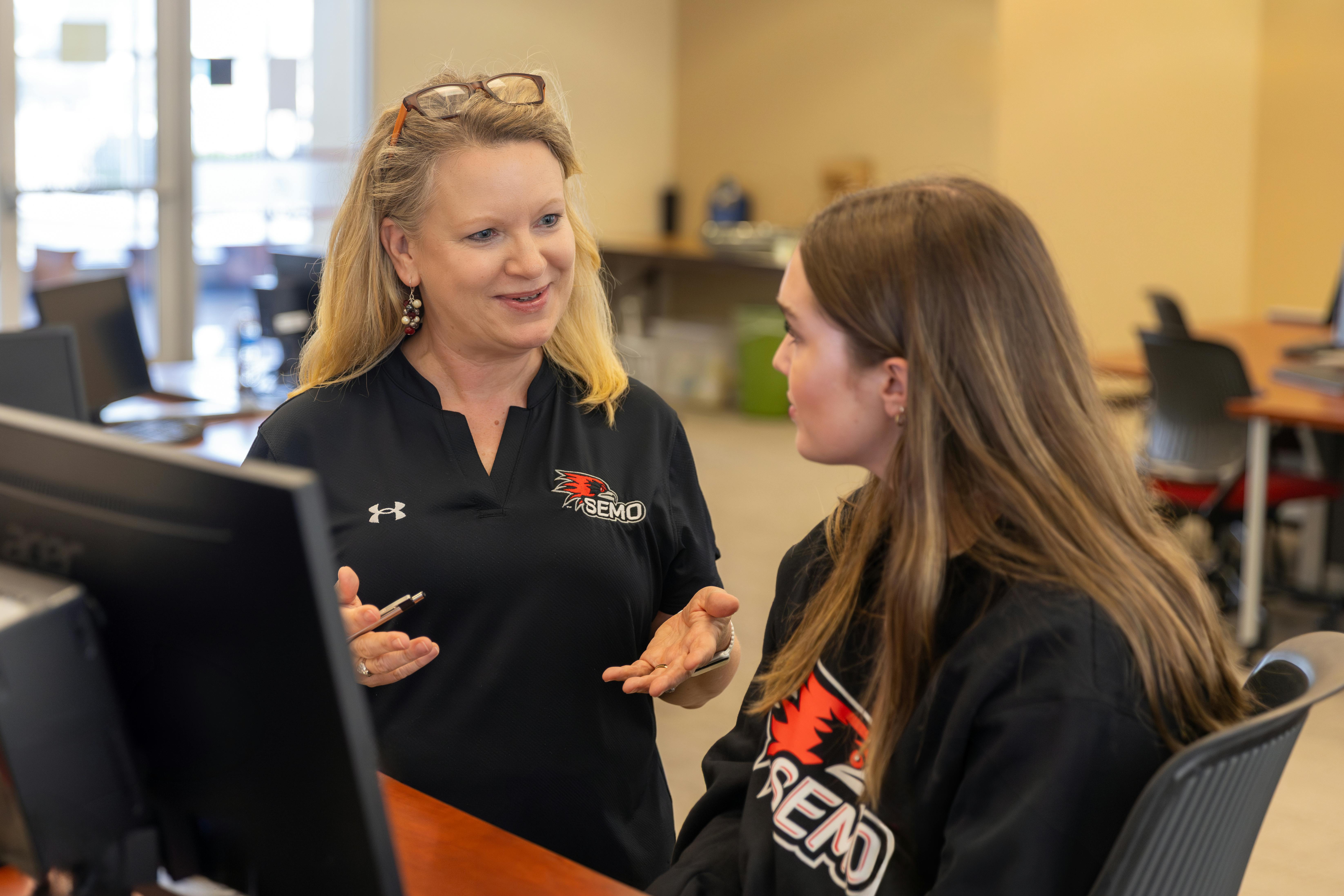 an advisor meeting with a student in our computer lab