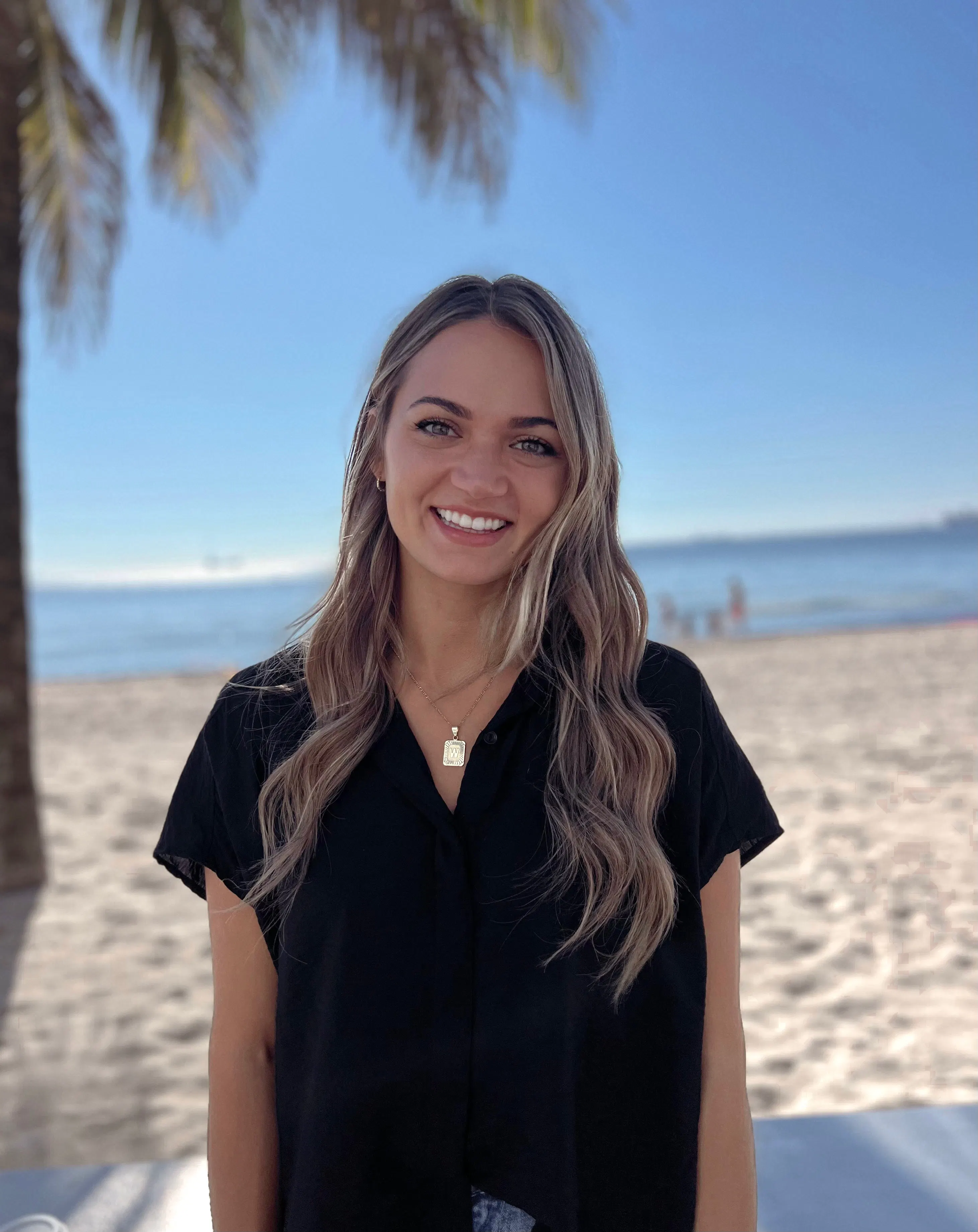 Communication Disorders Alumni, Whitley Chugunov, smiles at the camera.