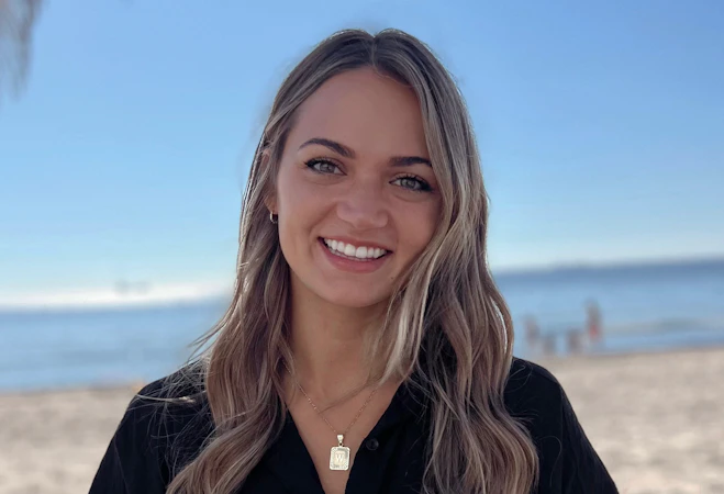Communication Disorders Alumni, Whitley Chugunov, smiles at the camera.