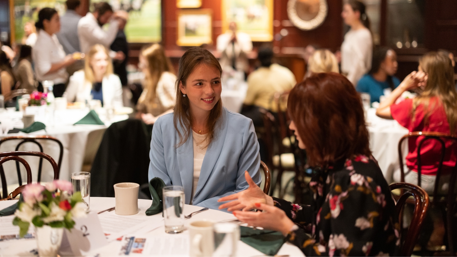 elm-pg-billboard-app DC - Mentor bfast woman in blue jacket at table with mentor