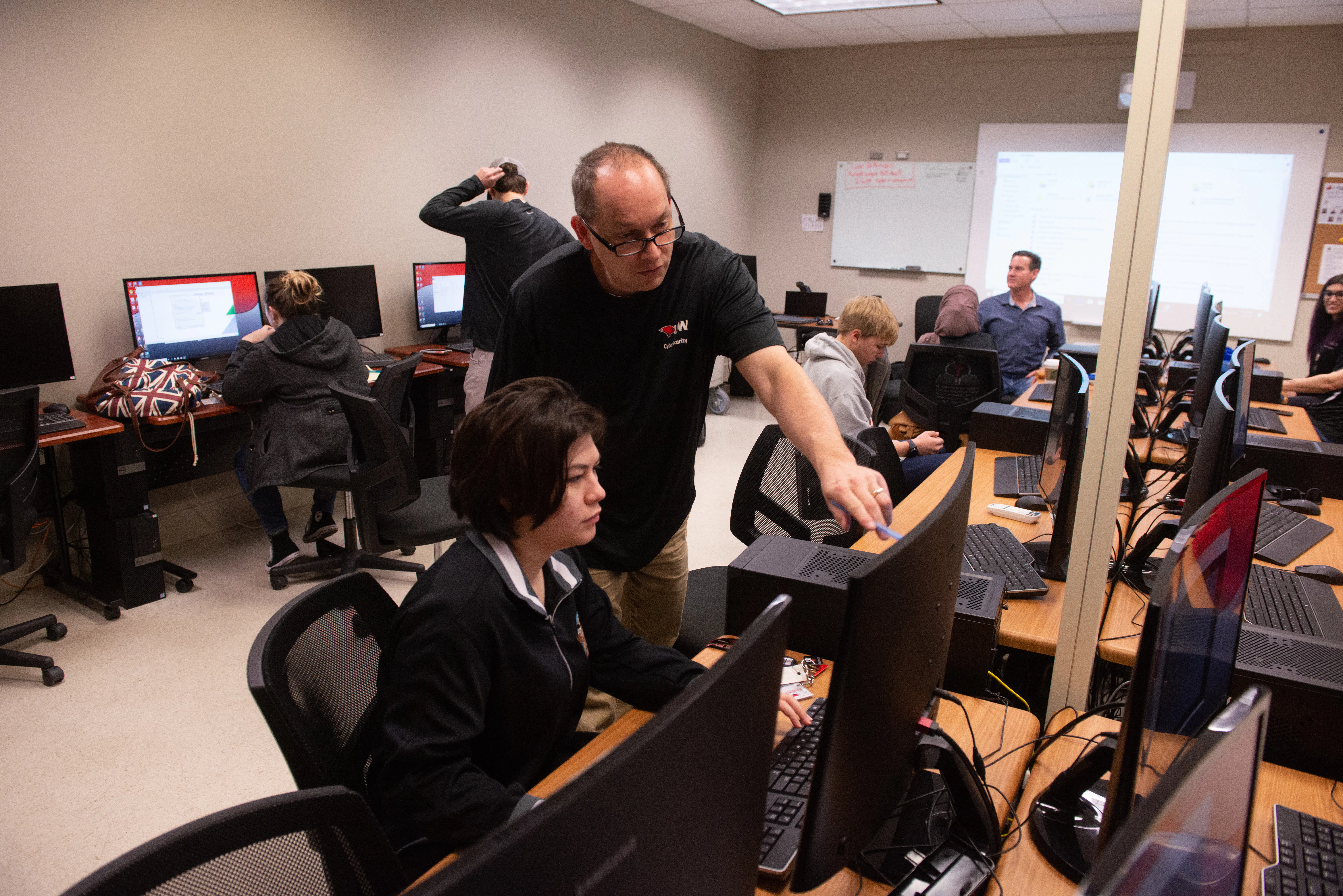 Data science professor instructing students in lab