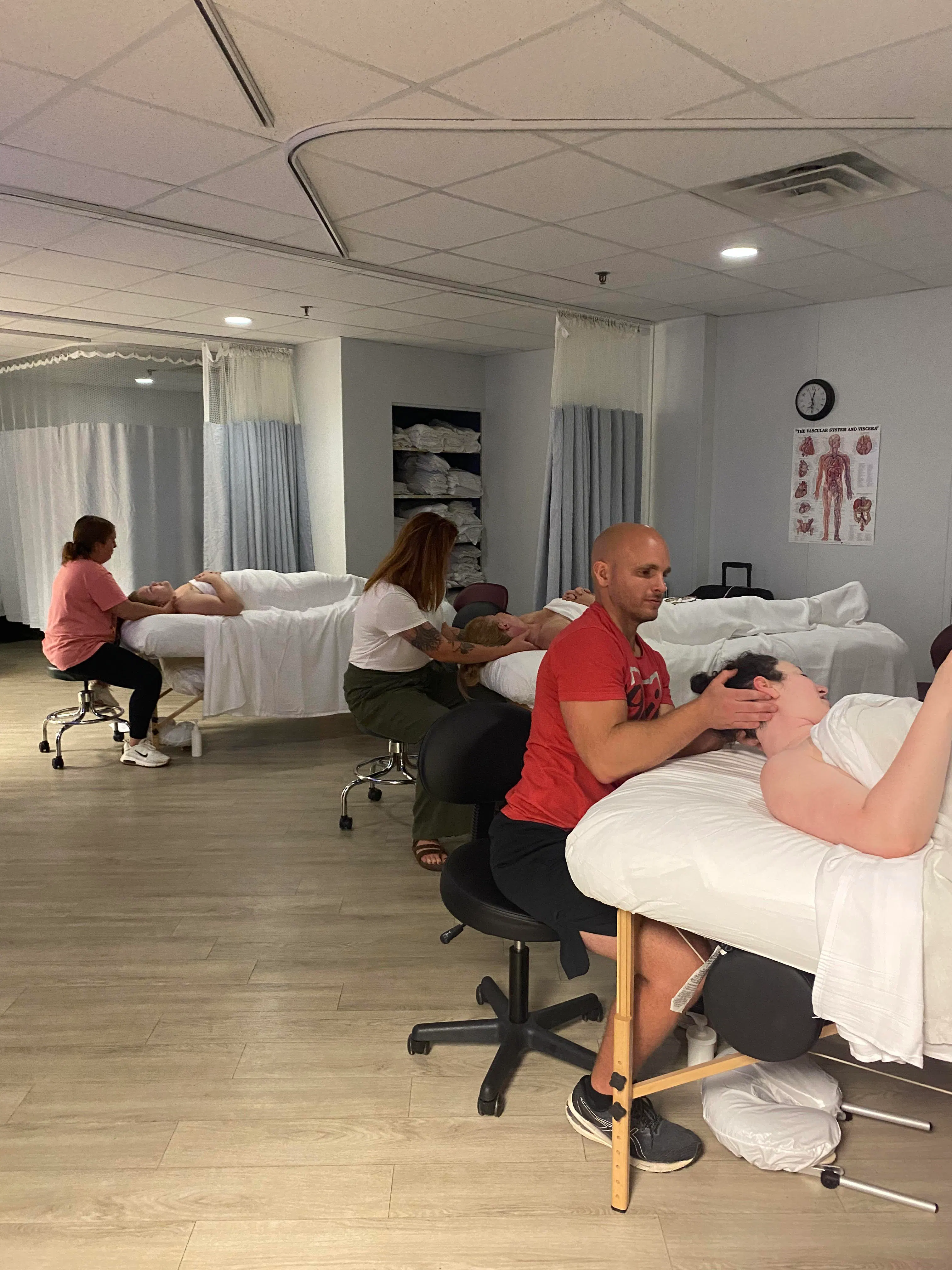 Massage students completing hands-on learning