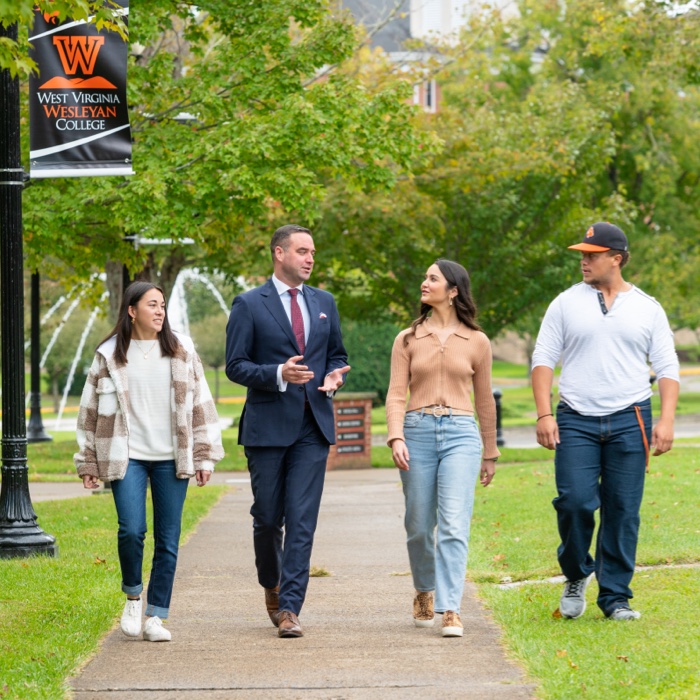Students and professor walking on campus